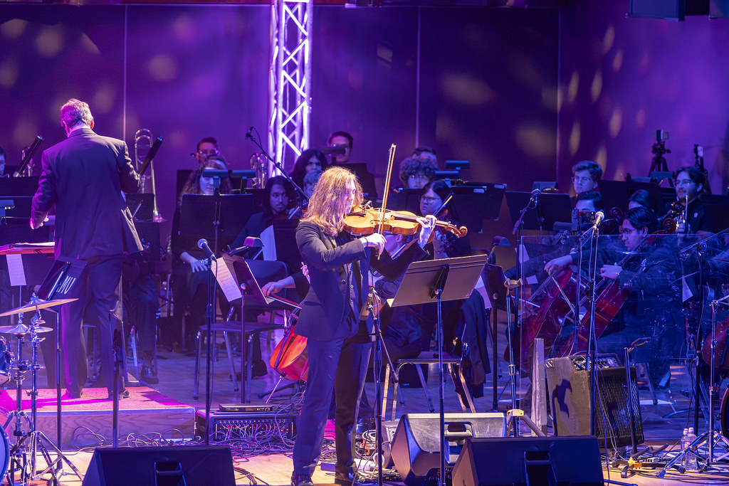 Viola soloist Patrick Williams plays Bohemian Rhapsody in front of the WT orchestra bathed in purple and white rock and roll lighting